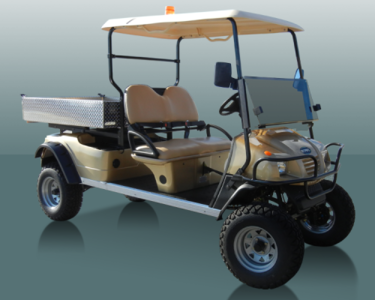 A tan and beige Star electric vehicle that is stationed in front of a dusty mint green colored backdrop.