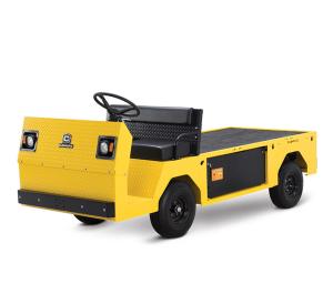 A yellow and black Cushman construction cart is parked in front of a white backdrop.