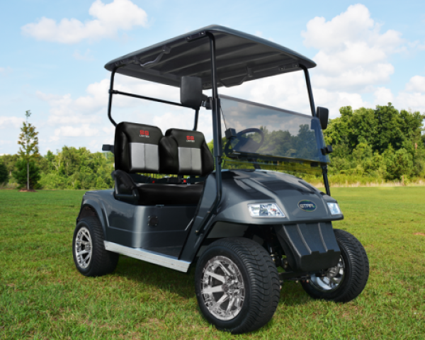 A black Star electric vehicle that is parked outside on the grass of a golf course.