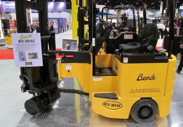 A black and yellow piece of heavy Bendi machinery is located in a showroom for sale.