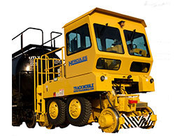 A large yellow Hercules railroad shunter is stationed in front of a white backdrop.